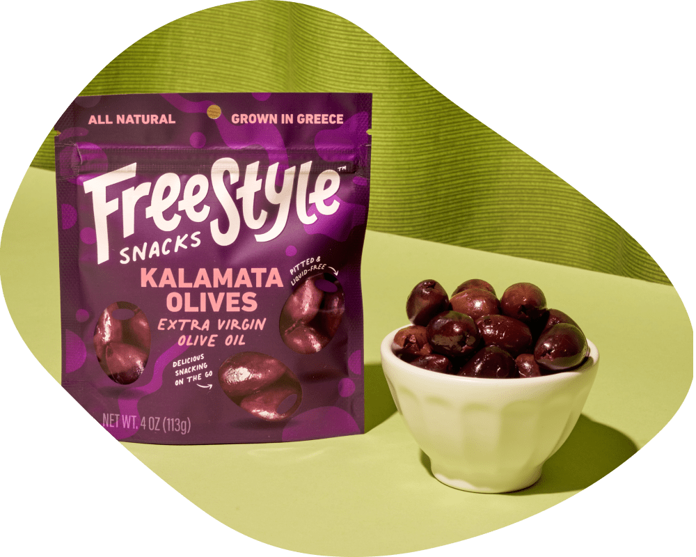 Freestyle Snacks Kalamata Olives packaging with a bowl of olives on a green background