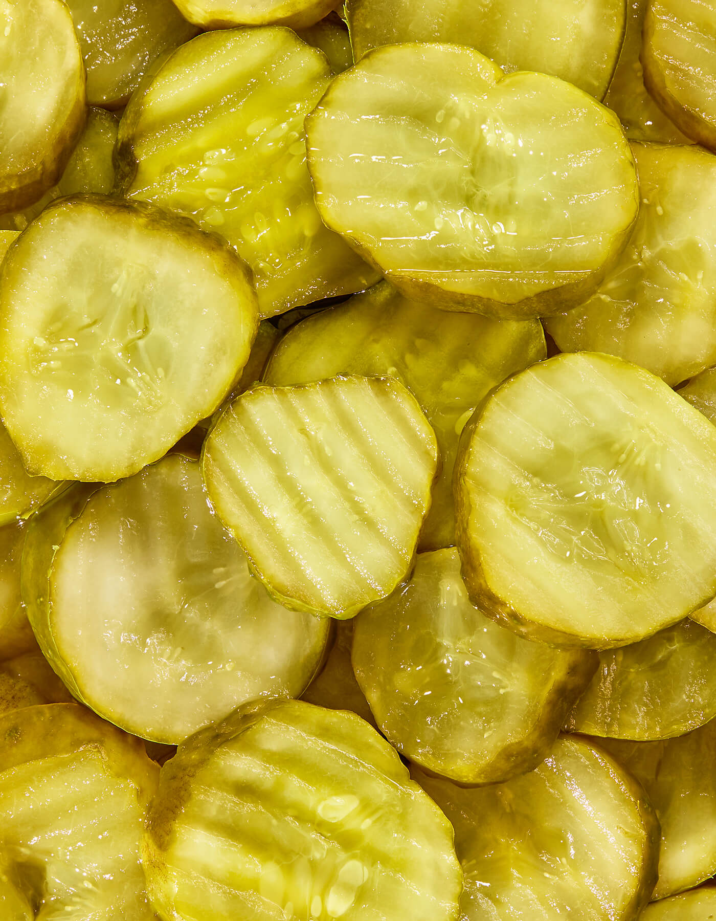 Close-up of sliced pickles, highlighting texture and color.