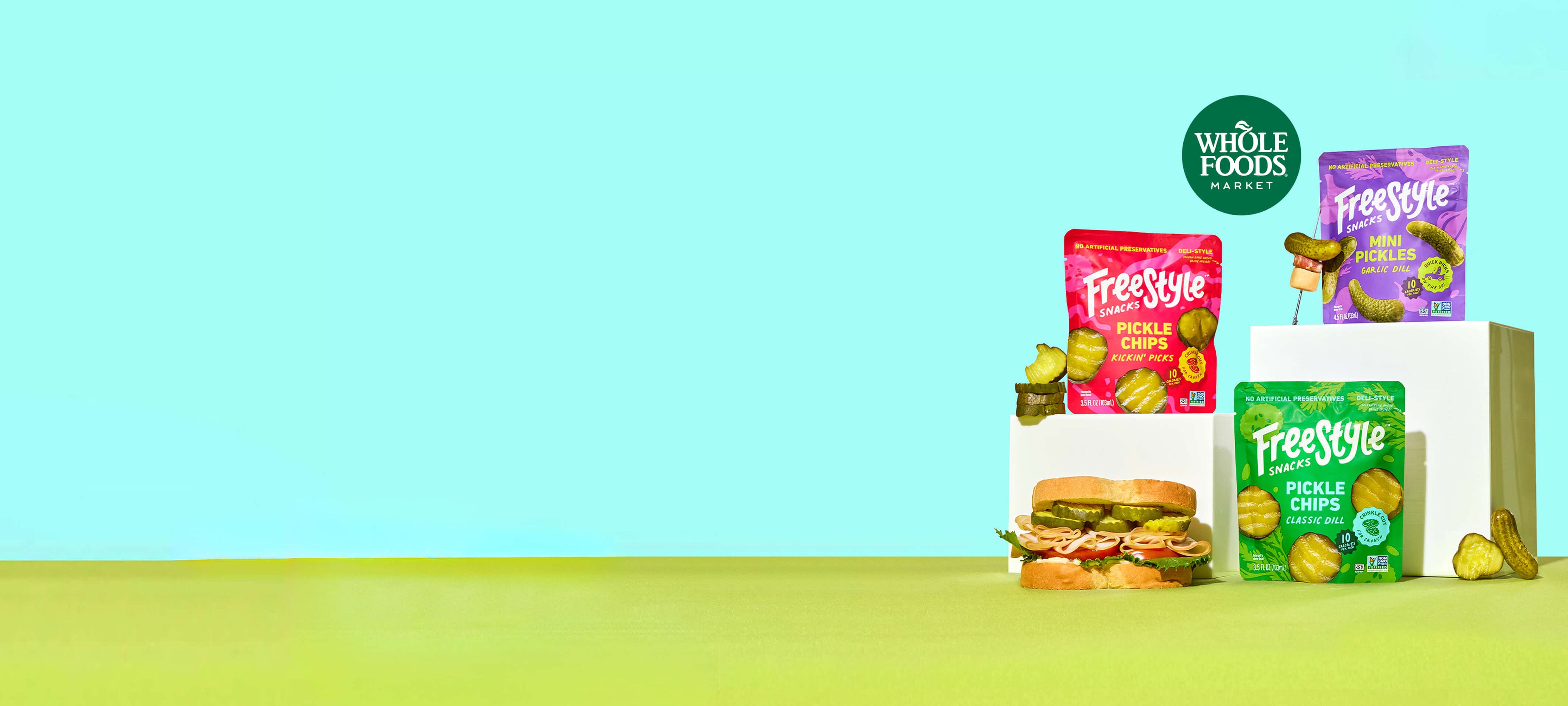 Assorted Freestyle Snacks including a sandwich and fruit on a white box with a blue background