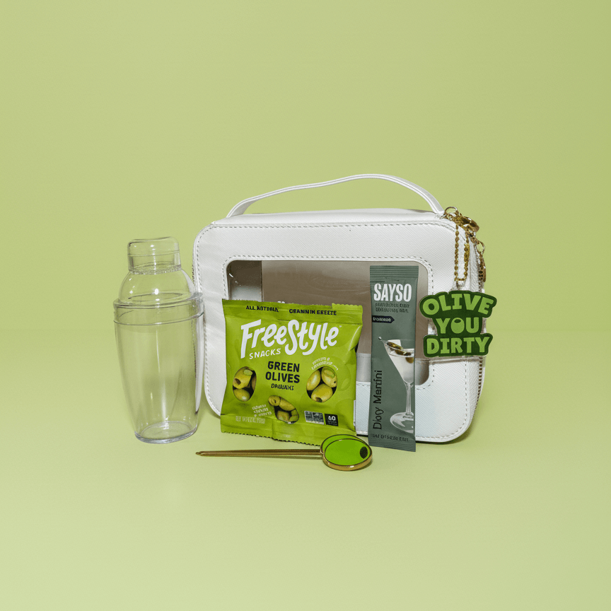 White handbag with green olives product and accessories on a light green background