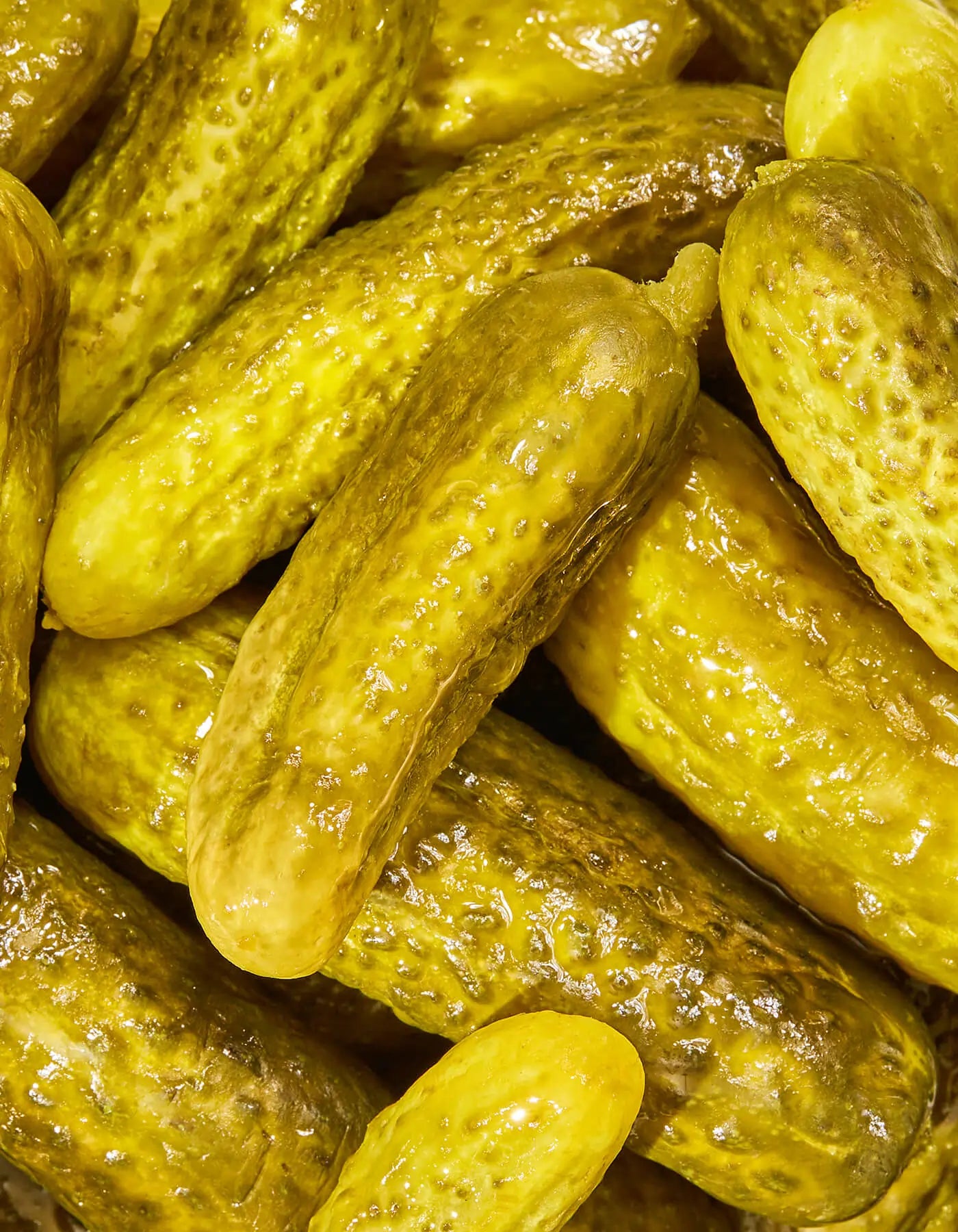 Close-up of pickled cucumbers with a focus on texture and color.