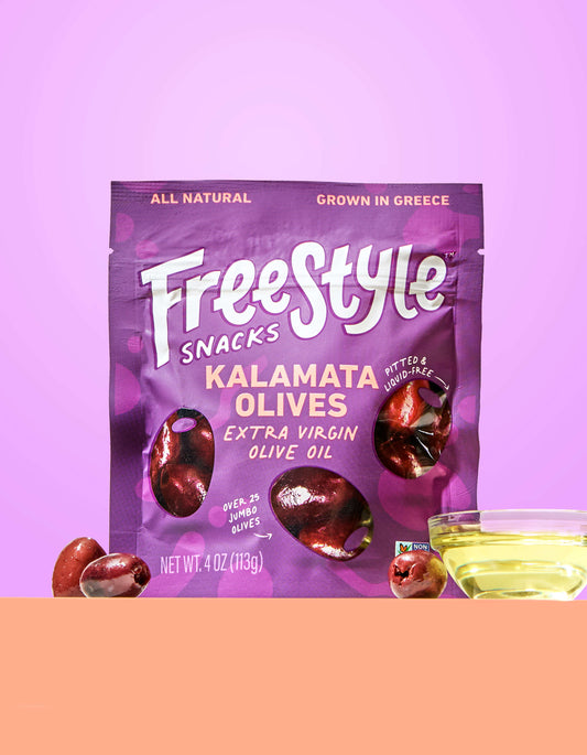 Freestyle Snacks Kalamata Olives package on a pink background