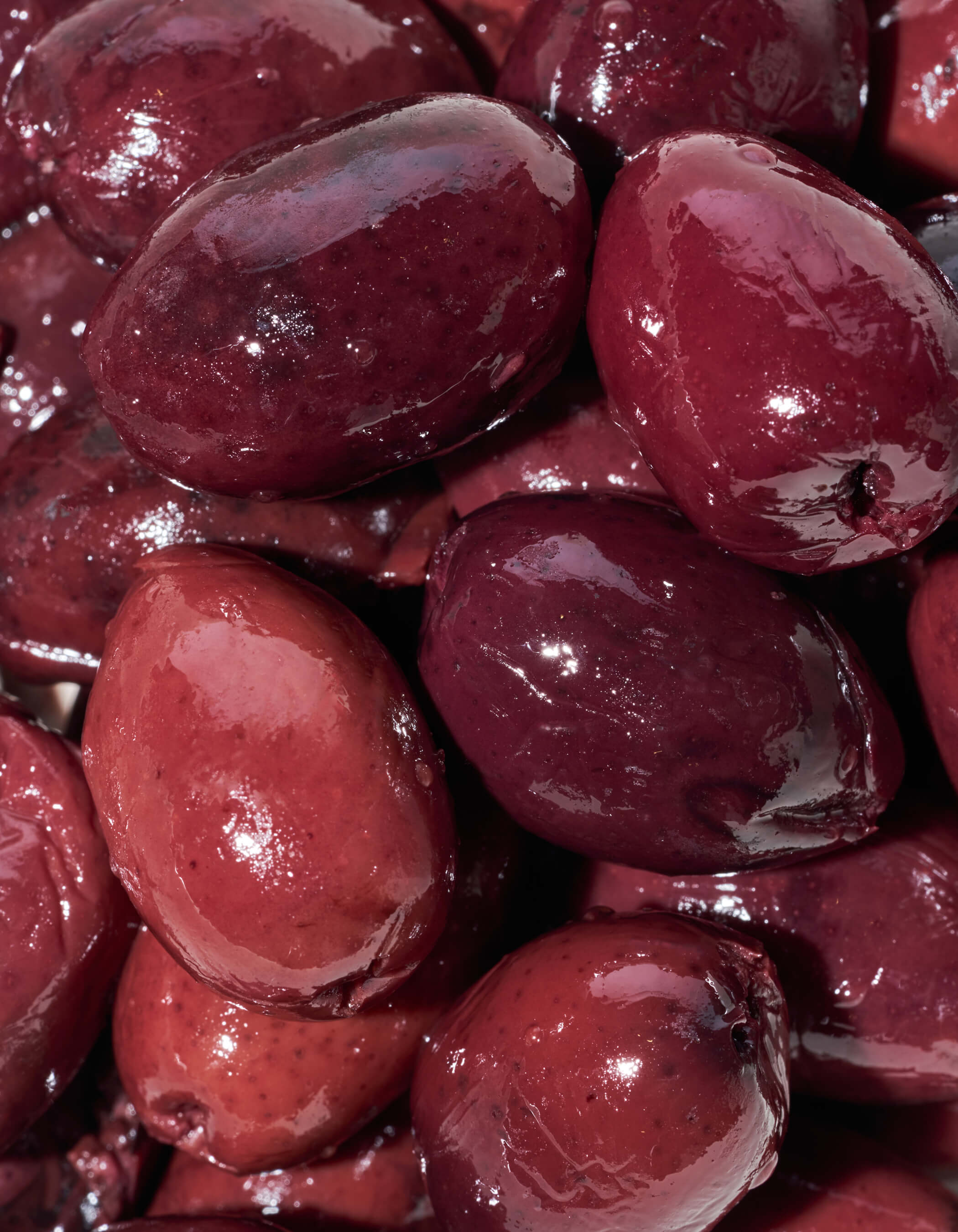 Close-up of glossy red olives