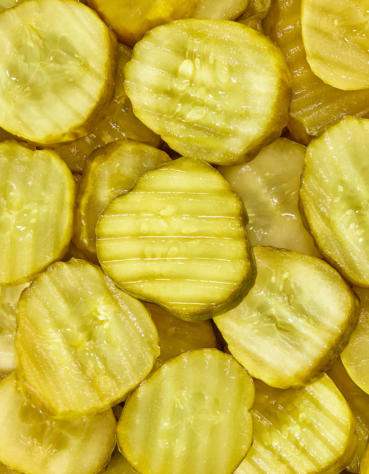 Close-up of sliced pickles with a focus on texture and color.