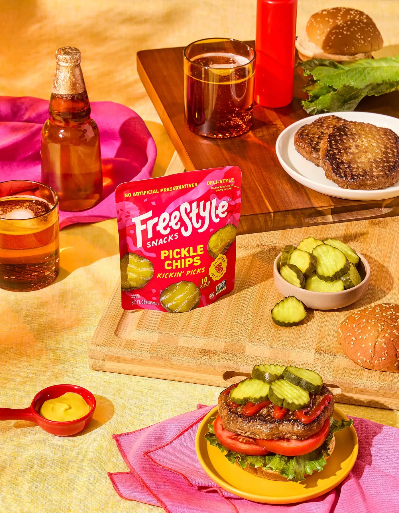 Freestyle Snacks Pickle Chips package with burgers and drinks on a table