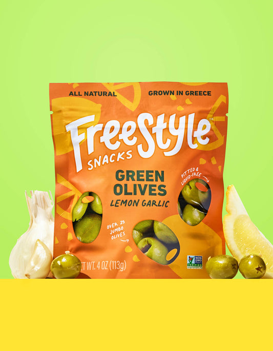 Freestyle Snacks Green Olives Lemon Garlic package on a green and yellow background