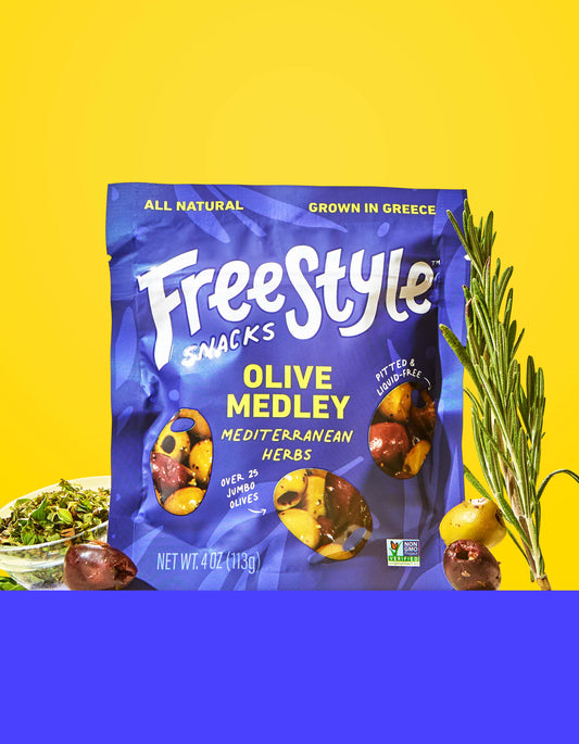 Freestyle Snacks Olive Medley Mediterranean Herbs package on a yellow background