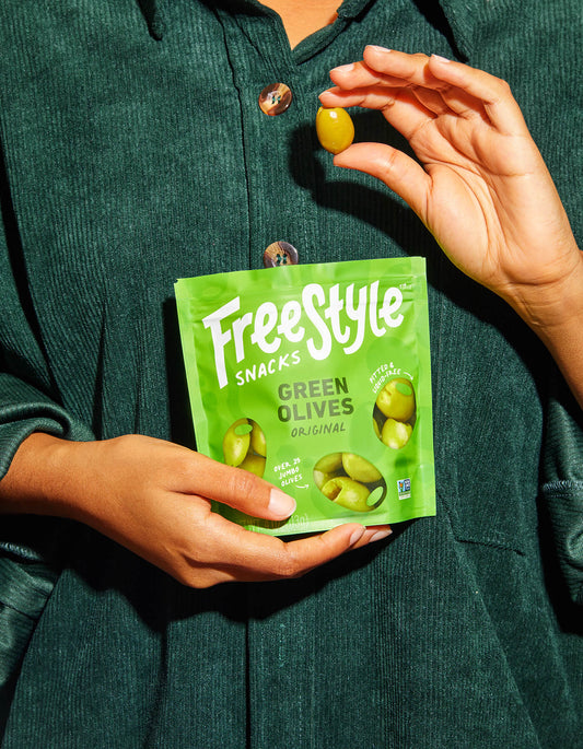 Person holding a Freestyle Snacks Green Olives packet